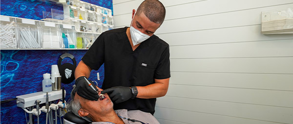 Dr. Gio with his patients at Flossy Smiles Dental Implants & Aesthetics for single tooth implant services