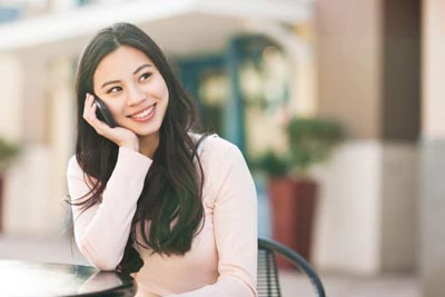 woman scheduling a dental appointment at Flossy Smiles