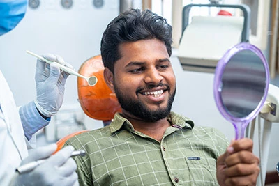 man smiling after getting same-day dental crowns at Flossy Smiles